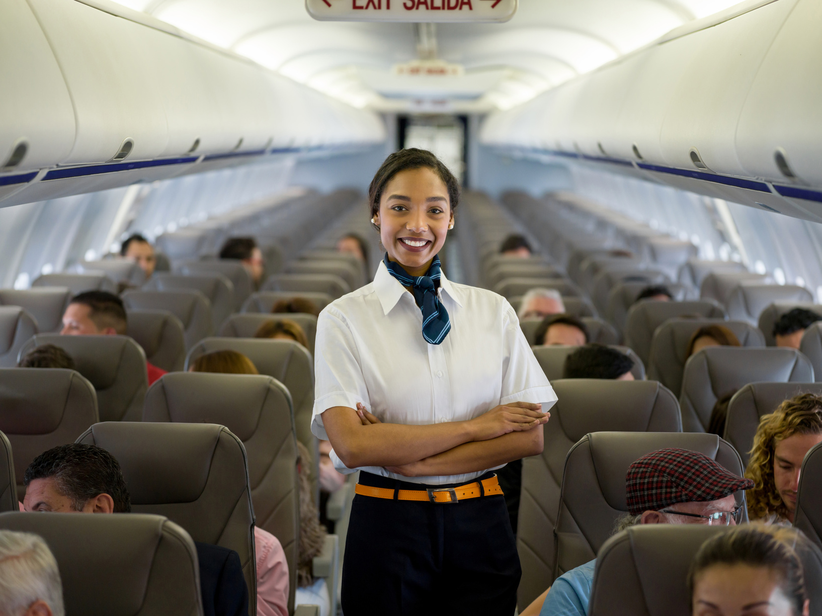 Beautiful African American flight attendant in an airplane