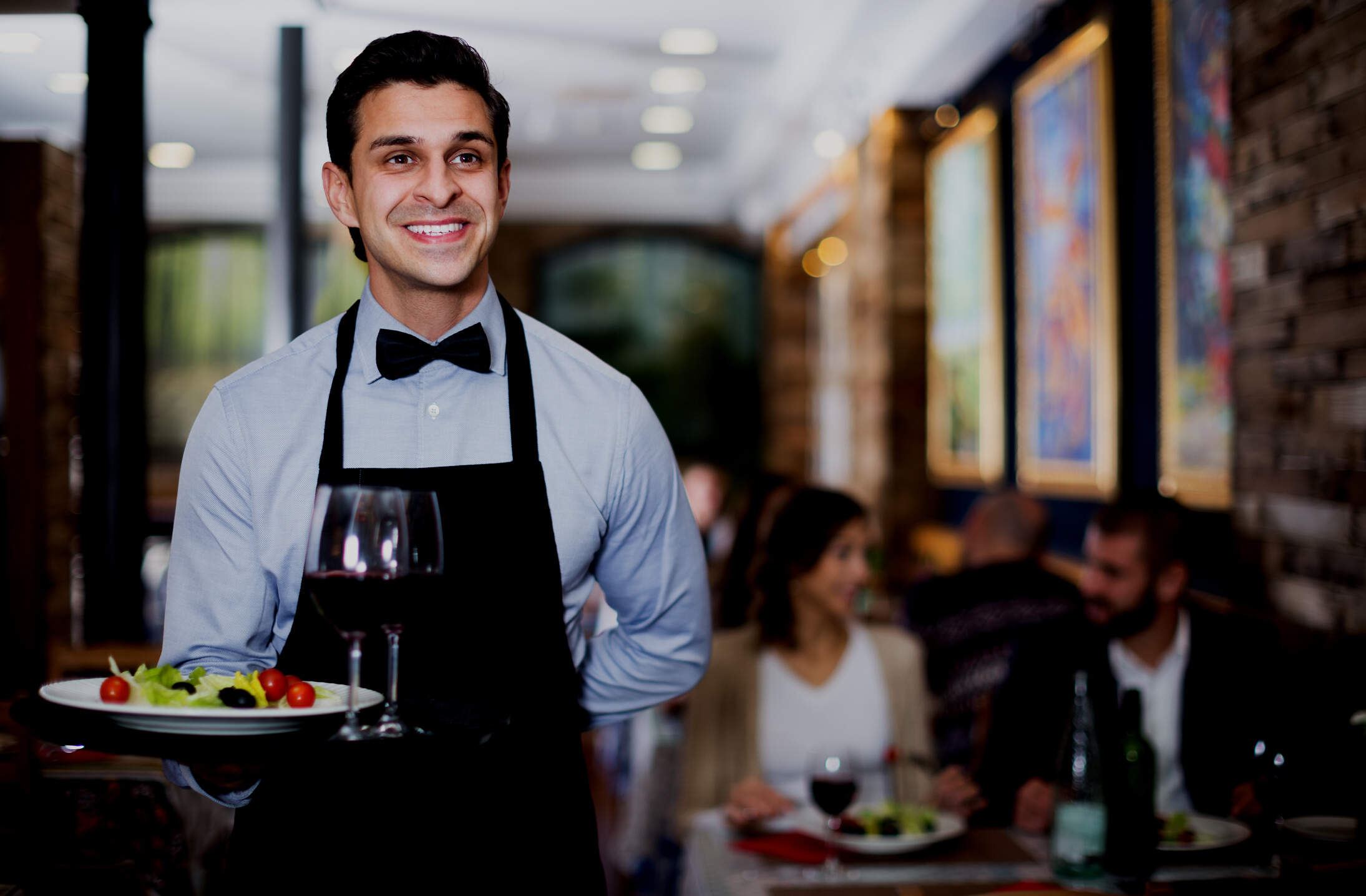 Waiter posing in restaurant